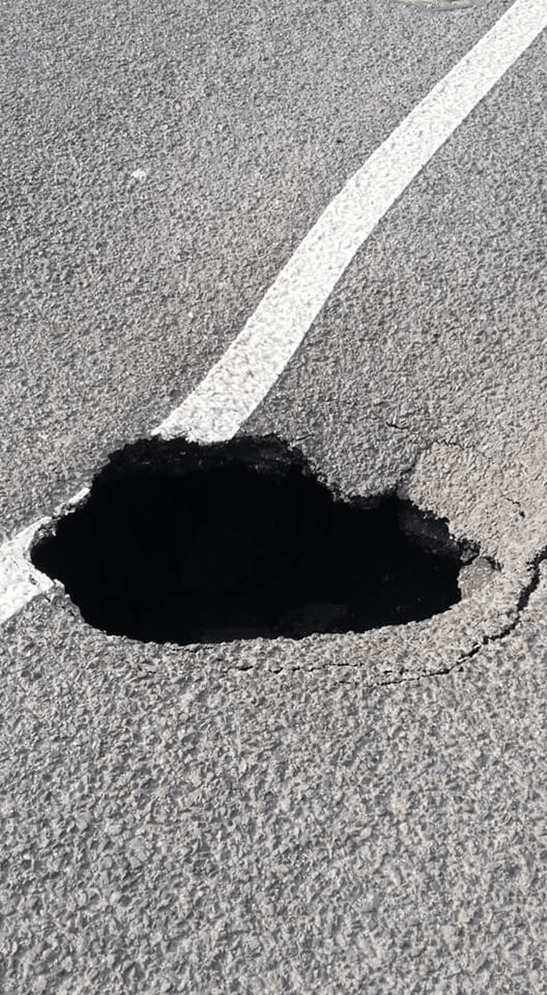 , schlagloch; Road closed in both directions after deep sinkhole appears
